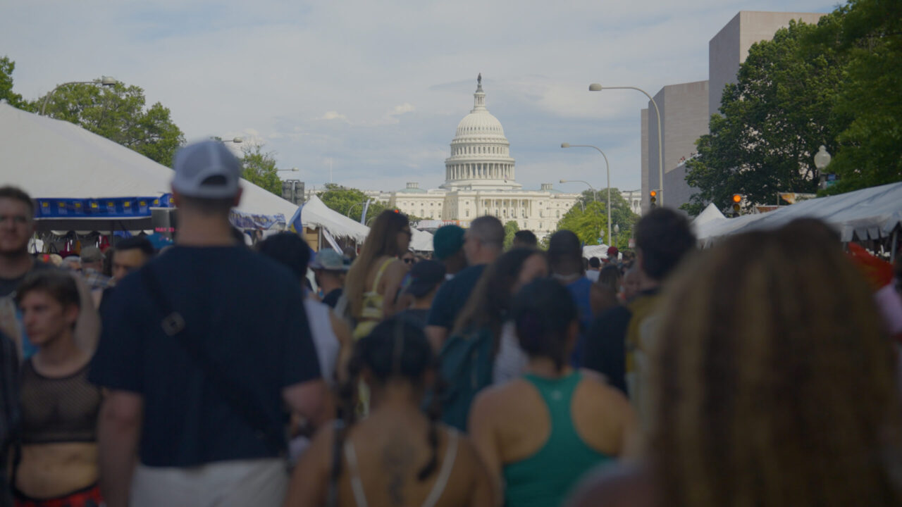 The U.S. Capitol building in Washington, D.C., looms above a street full of people.